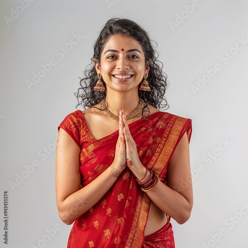  Girl wearing a red sari with hands in a namaste gesture