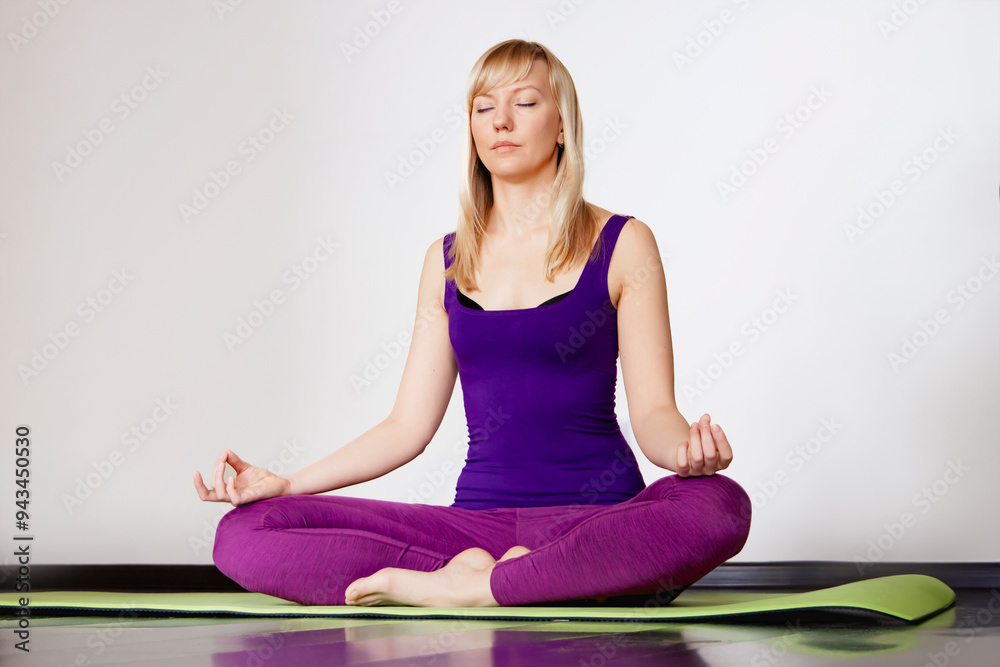 A Woman Meditating Comfortably on a Yoga Mat in a Calm, Relaxed, and Peaceful Position A Woman Meditating Comfortably on a Yoga Mat in a Calm, Relaxed, and Peaceful Position