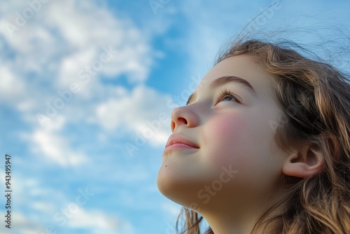 Contemplative Girl Underneath Puffy White Clouds