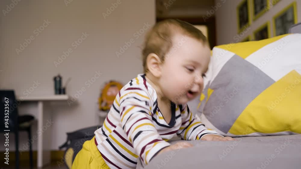 Smiling Baby Learning to Walk, Holding Onto Couch. Adorable Infant in Striped Onesie Standing with Support, Drooling Happily in Living Room Smiling Baby Learning to Walk, Holding Onto Couch. Adorable Infant in Striped Onesie Standing with Support, Drooling Happily in Living Room