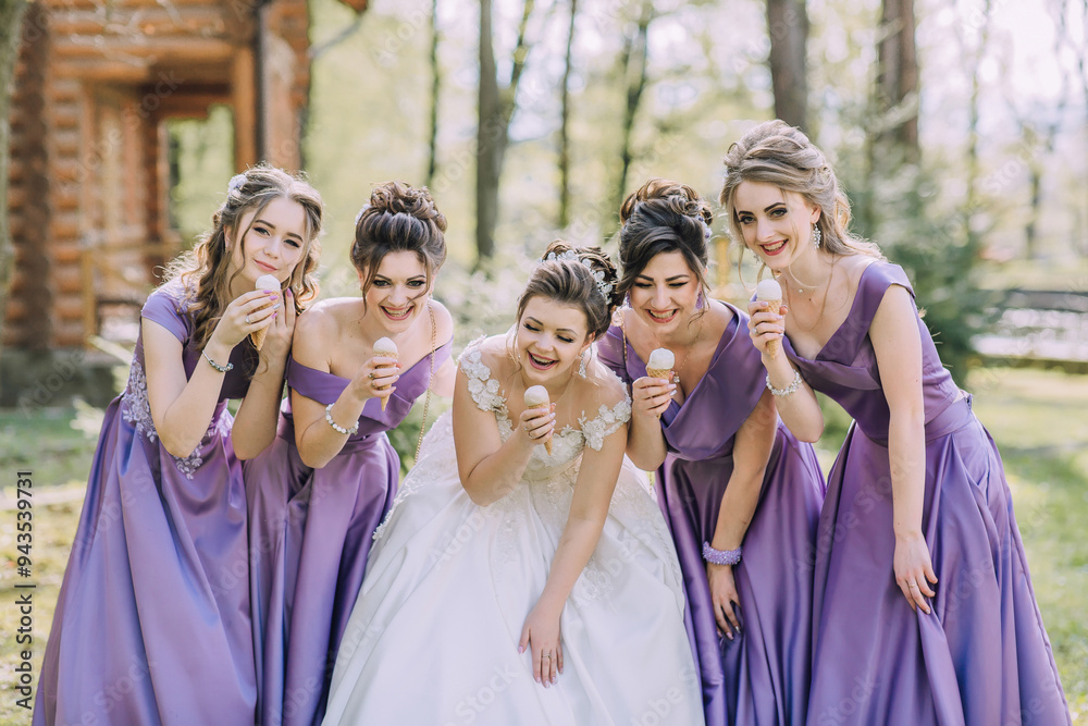 A group of women in purple dresses are posing for a photo while eating ice cream. Scene is lighthearted and fun, as the women are enjoying a sweet treat together A group of women in purple dresses are posing for a photo while eating ice cream. Scene is lighthearted and fun, as the women are enjoying a sweet treat together