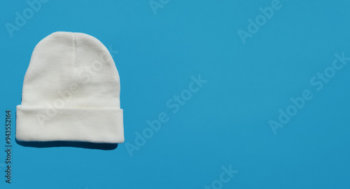 a white, warm, winter hat. knitted human headdress. an element of the wardrobe. background for the design.