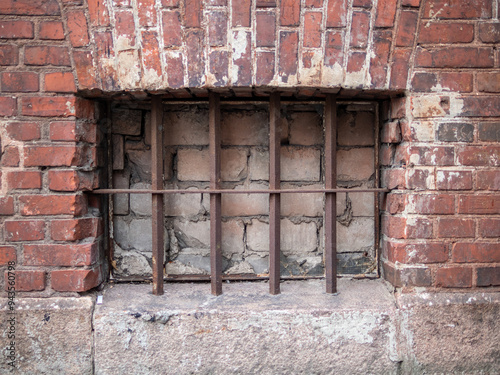 basement window blocked with bricks and bars photo