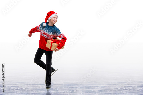 Boy figure skater in santa claus hat skating on ice isolated on white background. photo