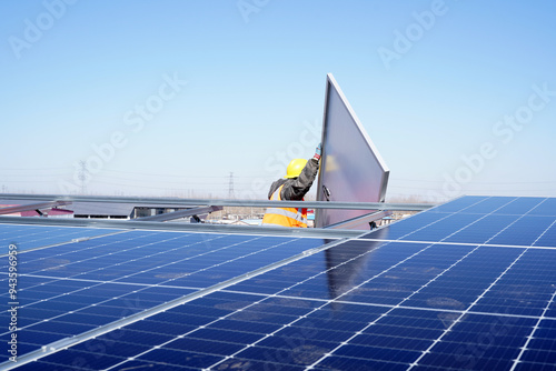 Workers install solar photovoltaic panels