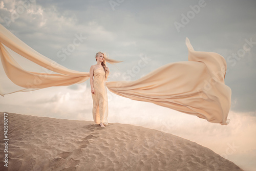 A blonde girl in a beautiful beige dress stands on a dune in the desert. the dress flutters beautifully in the wind. sunset.added various artistic
effects for the beauty of the photo