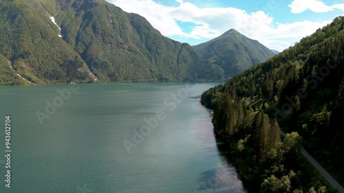 Breathtaking scenery of Fjaerlands Fjord, Norway, showcasing tranquil waters and towering mountains, perfect for travel enthusiasts and nature lovers photo