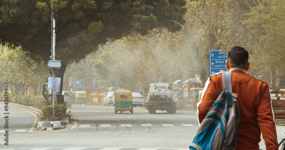 New Delhi, Delhi, India. Fire truck spraying water over Delhi streets amid pollution emergency. The government plans to spray the city with water in an attempt to clear the toxic smog cloud