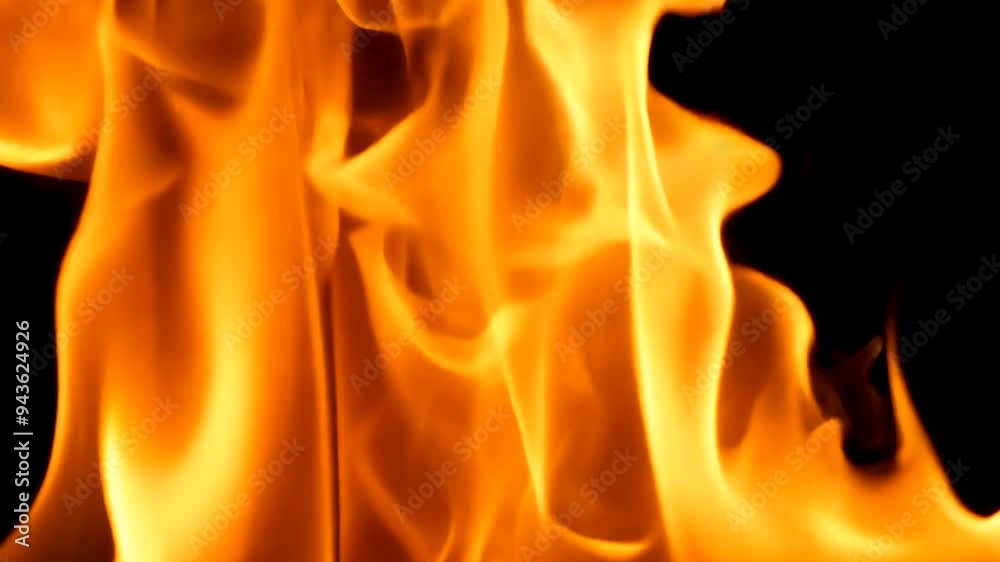 Flowing flames close-up on black background, ideal for intense and dramatic visual effects Flowing flames close-up on black background, ideal for intense and dramatic visual effects