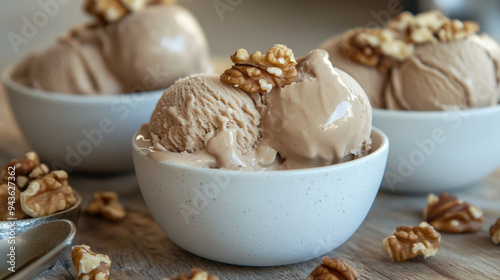 Walnut ice cream scoops in a glass.