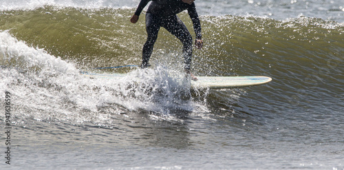 Side view of a surfer surfing on a wave off the coast of Long Islnad. photo