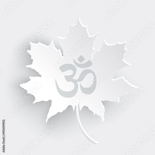 Om or Aum Indian sacred sound. Om symbol sign on maple leaf cut out of paper on white, grey background. The symbol of the divine triad of Brahma, Vishnu and Shiva. photo