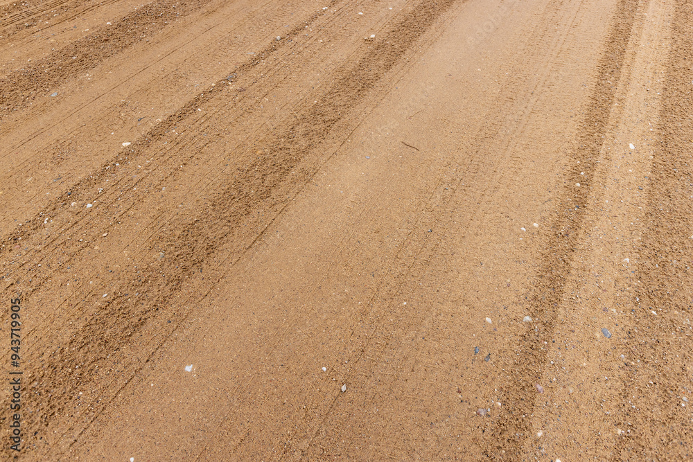Naklejka premium close-up of a part of a wet road without asphalt