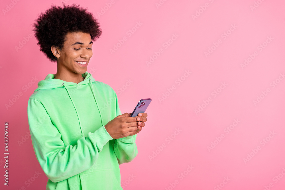 Portrait of cool young man smart phone empty space wear green hoodie isolated on pink color background Portrait of cool young man smart phone empty space wear green hoodie isolated on pink color background