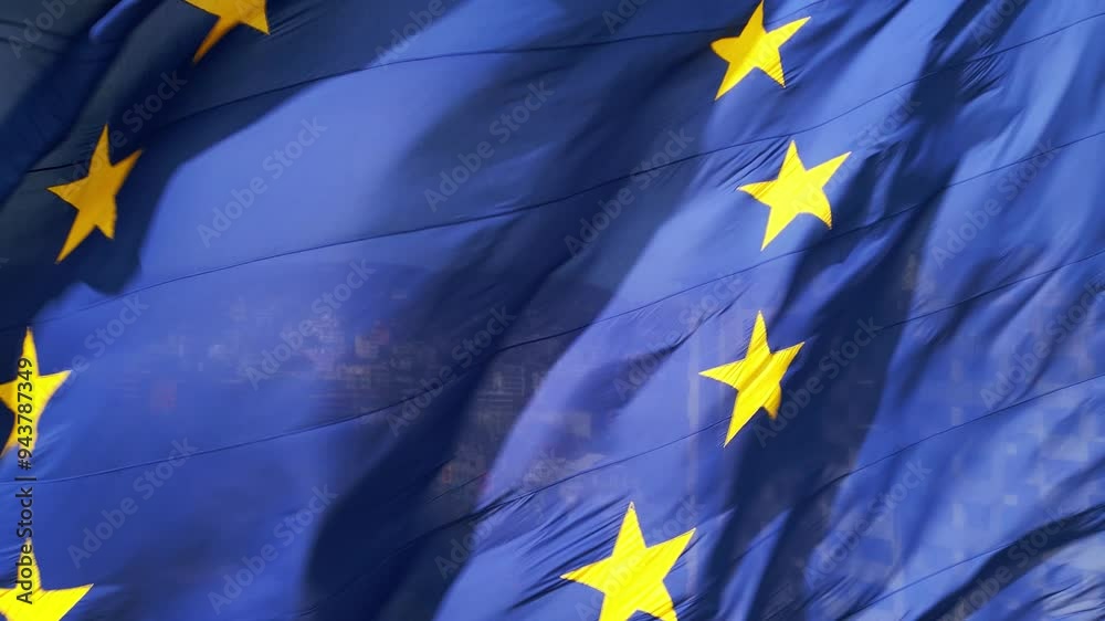 A close-up shot of the European Union flag waving in the wind, with its ...
