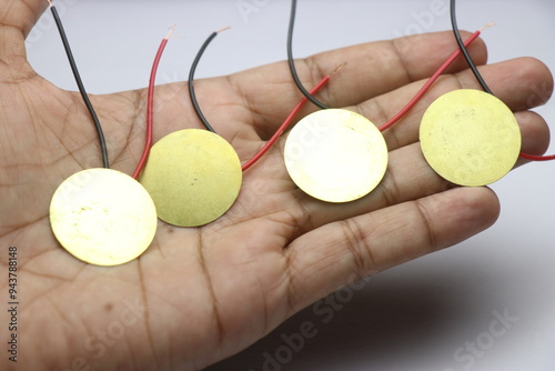 Piezoelectric plates with wires soldered used in electronic projects held in the hand