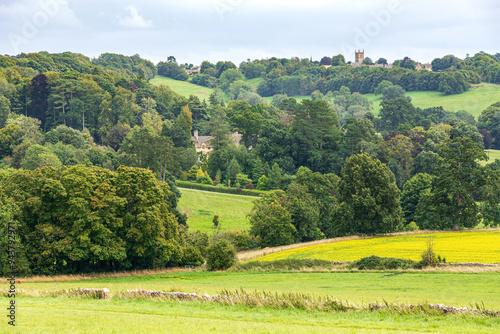 A glimpse of Abbotswood House from the west near the Cotswold village of Upper Swell, Gloucestershire, England UK - Stow on the Wold is behind to the right.