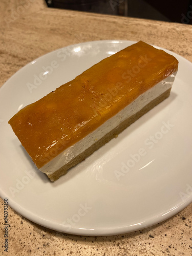 Rectangular Peach Cake or Cheese Cake servet at Coffee Shop. photo