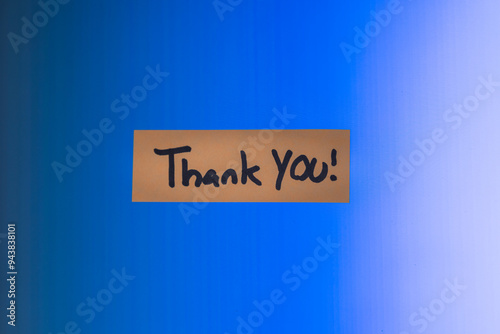 A thank you note on a computer screen. The note is on a blue screen background with a heavy vignette