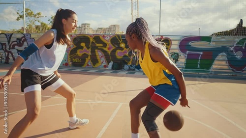 Cinematic footage of two professional basketball players playing and training outdoor at the sport court.