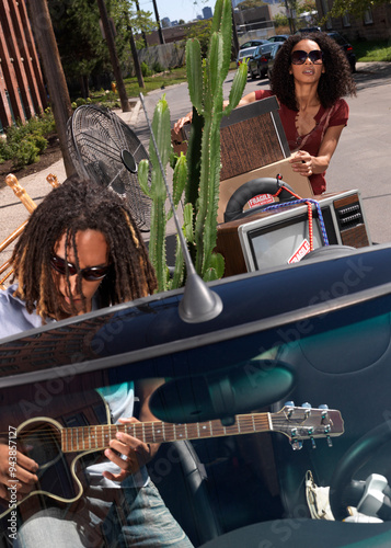 Couple Packing Car Full of Belongings photo