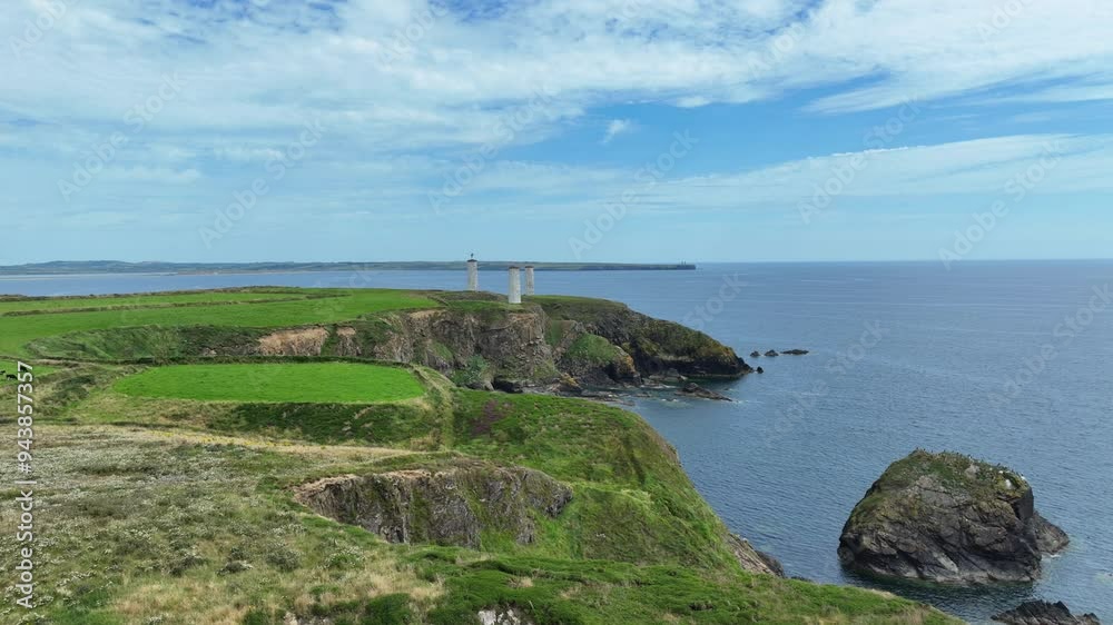 Ireland epic Locations drone flying slowly along Waterford coast to metal man towers at the entrance to Tramore bay Ireland Ireland epic Locations drone flying slowly along Waterford coast to metal man towers at the entrance to Tramore bay Ireland