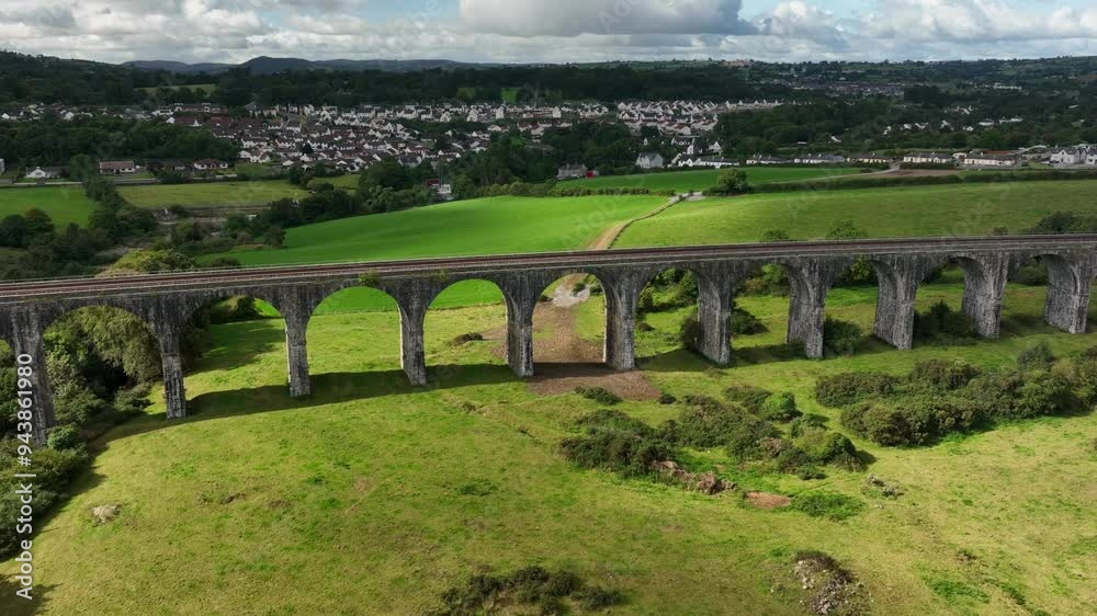 Craigmore Viaduct, County Armagh, Northern Ireland, September 2022. Drone tracks left along the old Railway Bridge with Newry town in the background on a Autumn day with sunny spells.