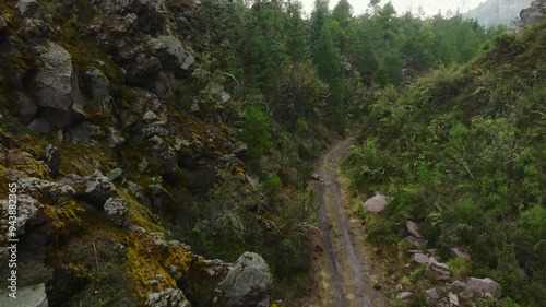 Tracks On The Rugged Mountains Near Colima's Fire Volcano, El Playon Trail In Jalisco, Mexico Aerial Pullback Shot photo