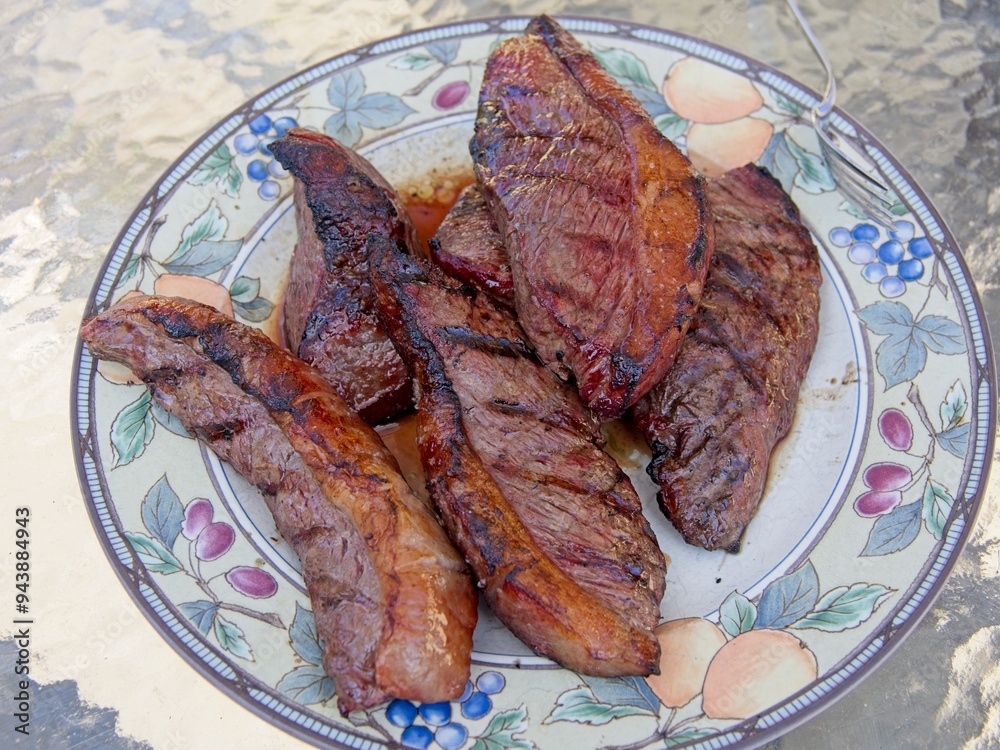 Picanha, or top sirloin cap, steaks on a charcoal grill