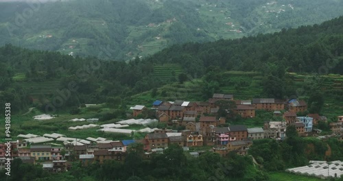 Drone shot of a traditional Nepali village in hills of Chitlang, Makwanpur. The serene landscape shows lush greenery and a peaceful, authentic rural lifestyle amidst the scenic beauty of Nepal. photo