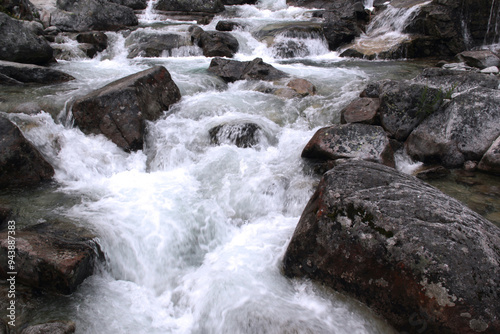 Close-up photo of the part of Vodopady Studeneho potoka waterfall among large stones near Stary Smokovec in Vysoke Tatry region, Slovakia	
 photo