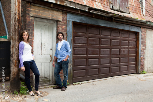 Portrait of Young Couple Standing in Alleyway, Toronto, Ontario, Canada photo