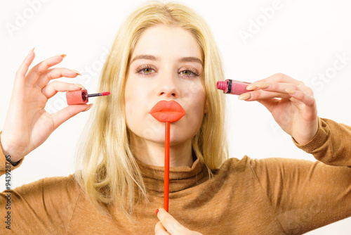 Woman applying lipstick or lip gloss photo