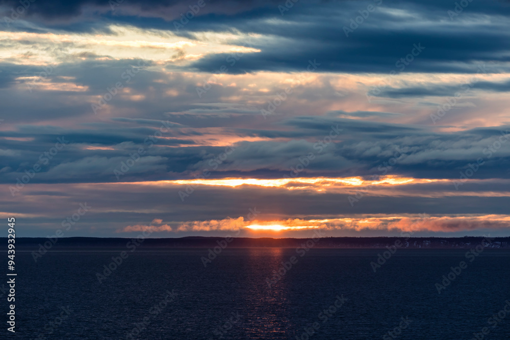 Dramatic clouds at the last light of sunset over the ocean at Turnagain Arm in Carr-Gottstein Park near Anchorage; Anchorage, Alaska, United States of America Dramatic clouds at the last light of sunset over the ocean at Turnagain Arm in Carr-Gottstein Park near Anchorage; Anchorage, Alaska, United States of America