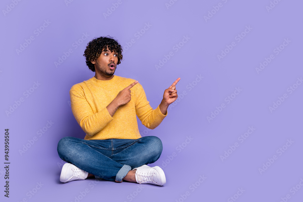 Photo of excited astonished man wear trendy clothes demonstrate news empty space isolated on purple color background Photo of excited astonished man wear trendy clothes demonstrate news empty space isolated on purple color background