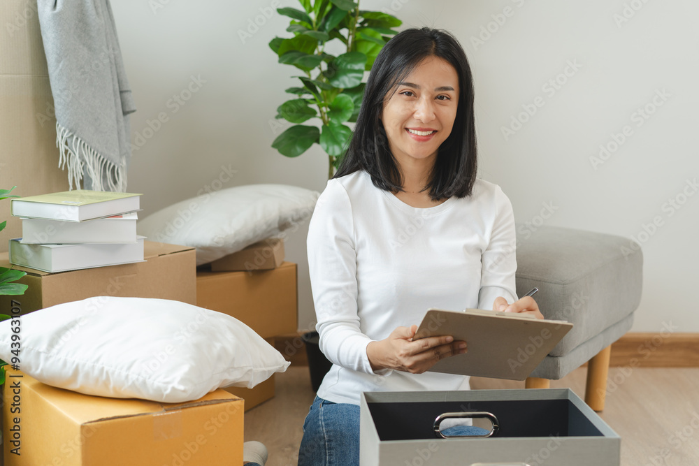 Happy woman checking stuff in cardboard box before sent to transportation company and moving to new location apartment. Happy woman checking stuff in cardboard box before sent to transportation company and moving to new location apartment.
