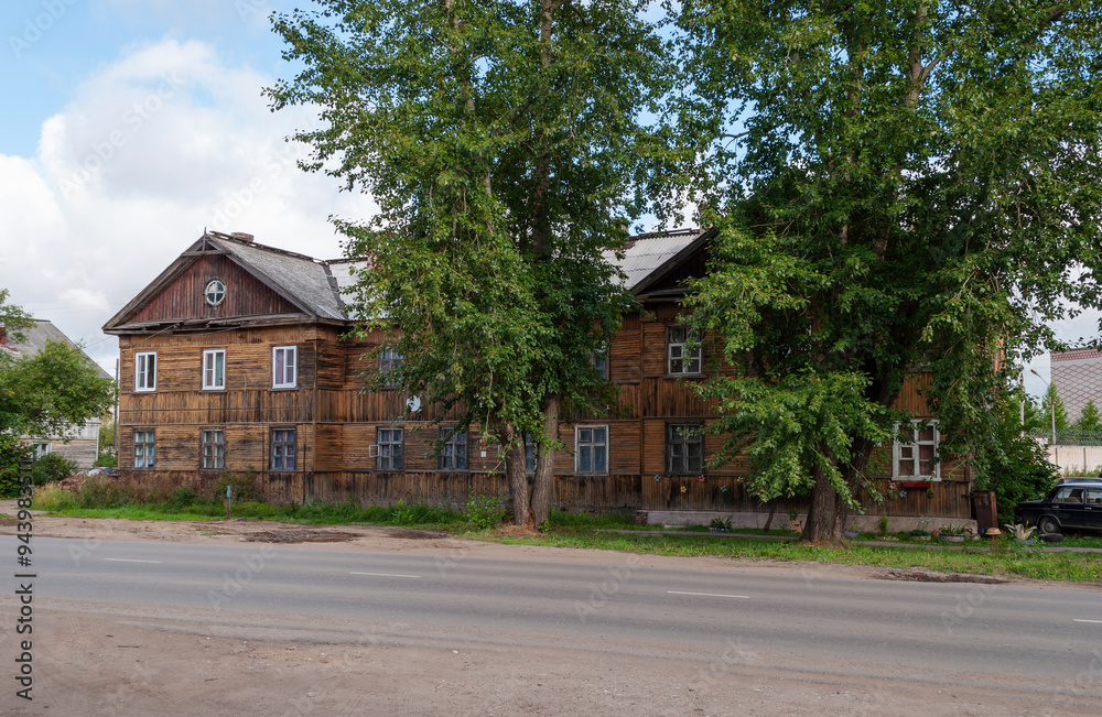 Old traditional two-storey wooden building in Kotlas, Arkhangelsk region, Russia Old traditional two-storey wooden building in Kotlas, Arkhangelsk region, Russia