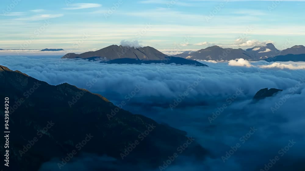 Exploring breathtaking mountain landscapes above the clouds at sunrise in a remote wilderness region Exploring breathtaking mountain landscapes above the clouds at sunrise in a remote wilderness region