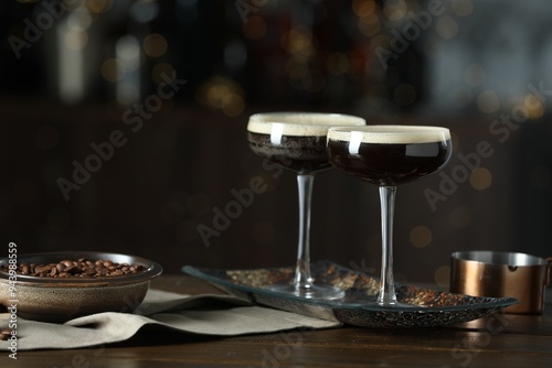 Refreshing cocktails and coffee beans on wooden table