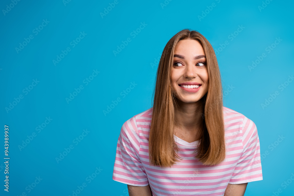 Photo portrait of adorable nice glad woman wear stylish striped pink clothes look empty space isolated on blue color background