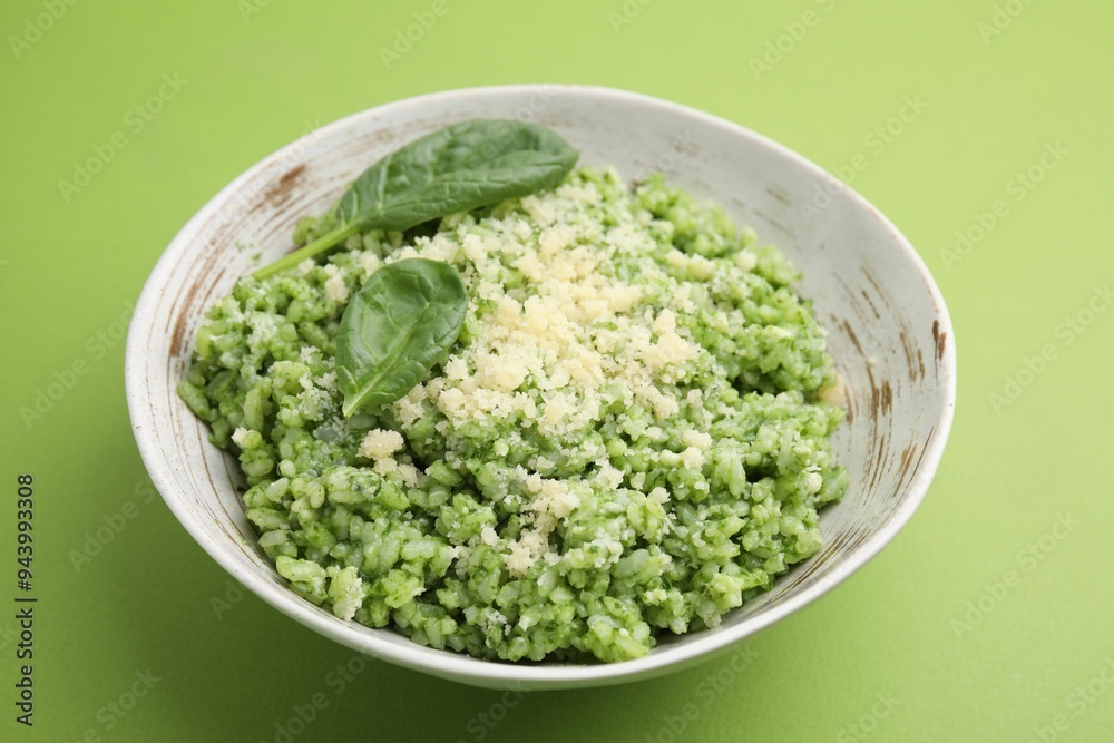 Tasty spinach risotto on light green background, closeup Tasty spinach risotto on light green background, closeup