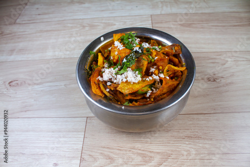 batatyachya kachrya is an indian potato dish served in steel bowl. food of Maharashtra.