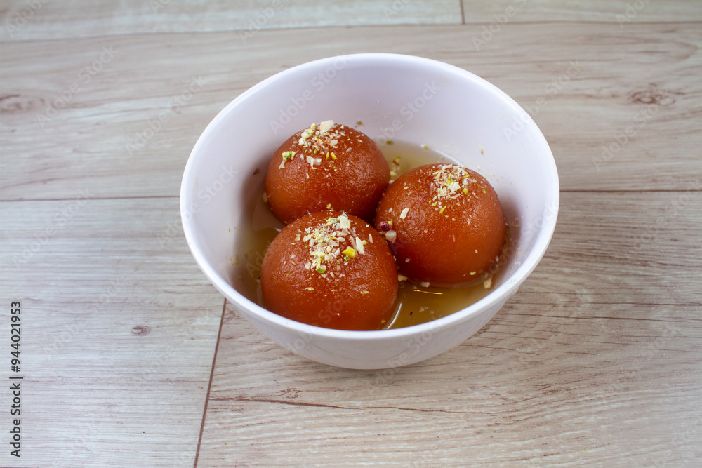 Sweet Gulab Jamun served in White bowl, Famous Indian dessert sweets isolated indoor studio background Sweet Gulab Jamun served in White bowl, Famous Indian dessert sweets isolated indoor studio background