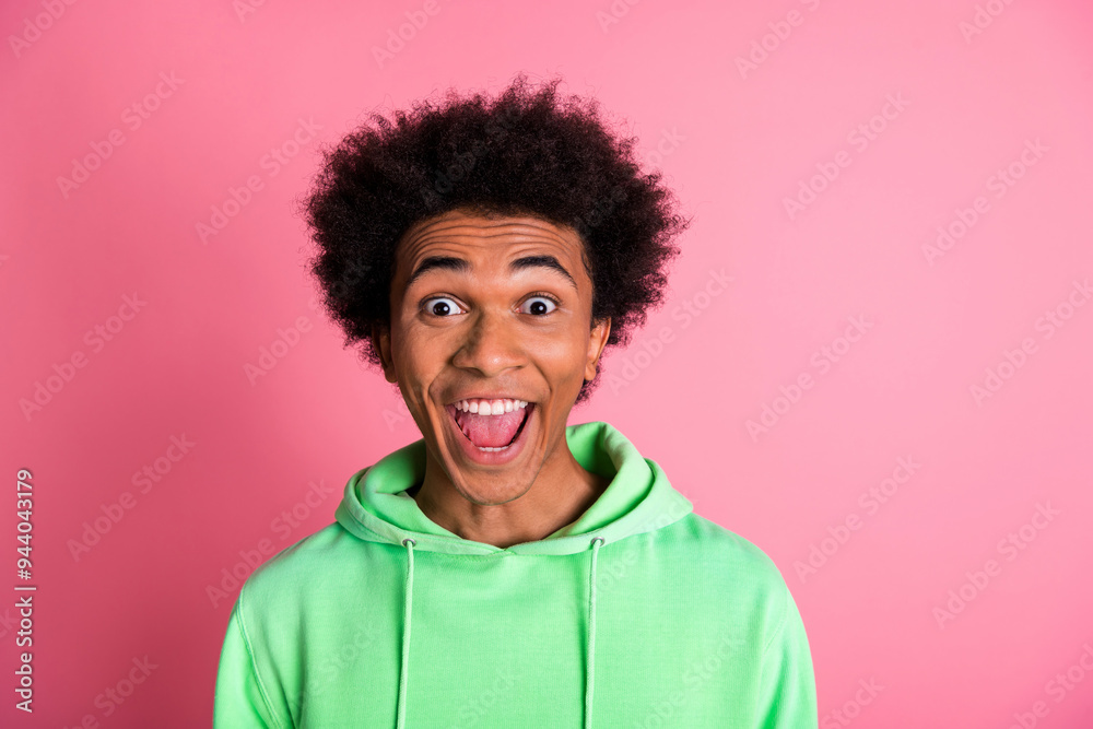 Portrait of nice young man open mouth empty space wear green hoodie isolared on pink color background Portrait of nice young man open mouth empty space wear green hoodie isolared on pink color background