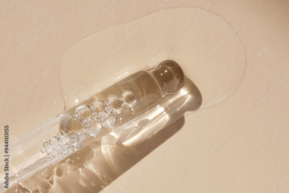 Naklejka premium Pipette with serum on a beige background.