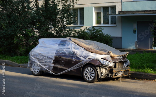 A black car, crashed after an accident, is parked in the courtyard of an apartment building, Podvoysky Street, St. Petersburg, Russia, August 27, 2024 photo