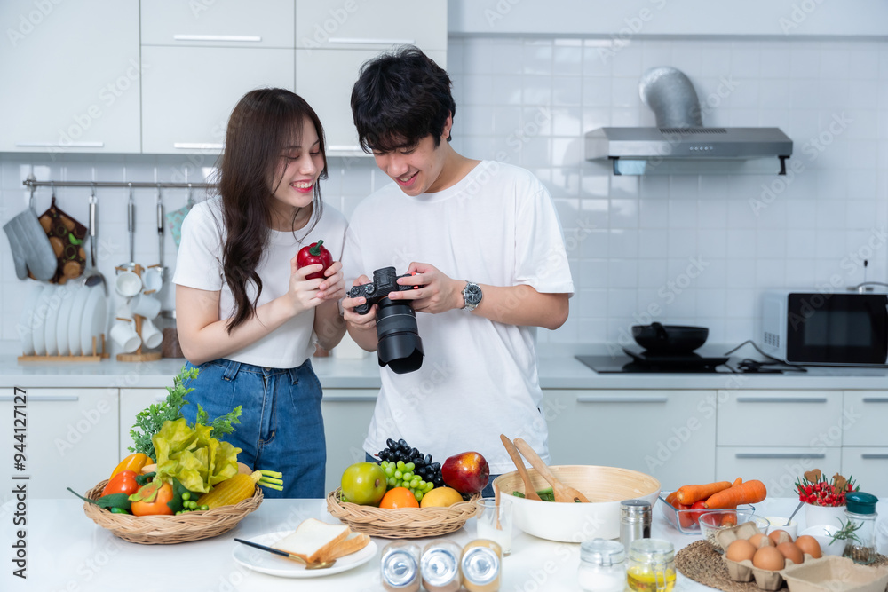 Happy portrait of loving young asian of having fun standing Take a photo after enjoy cook cooking with vegetables, meat, bread while standing on a kitchen Condo life or home Happy portrait of loving young asian of having fun standing Take a photo after enjoy cook cooking with vegetables, meat, bread while standing on a kitchen Condo life or home