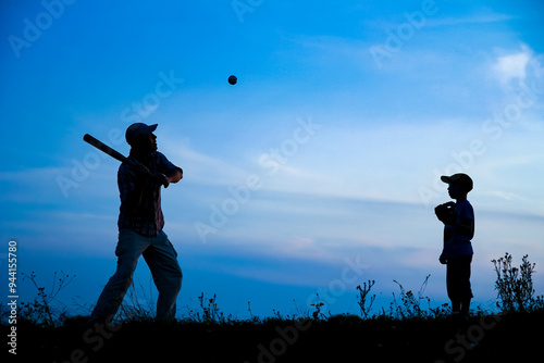 A Happy child with parent playing baseball concept in park in nature