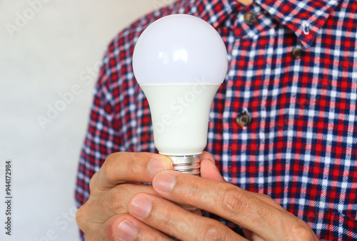 A  man hand holding a bulb