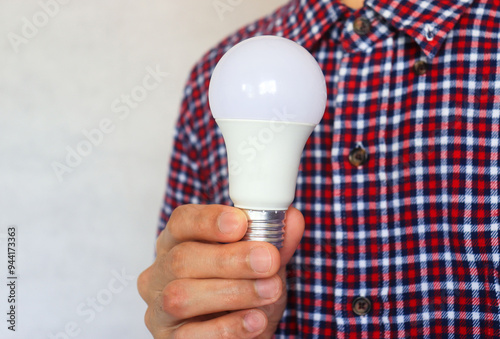 A  man hand holding a bulb